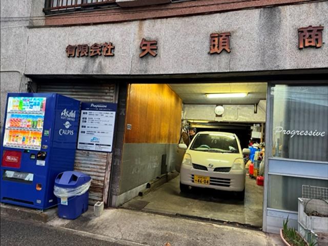 工場の入口に停まる軽自動車